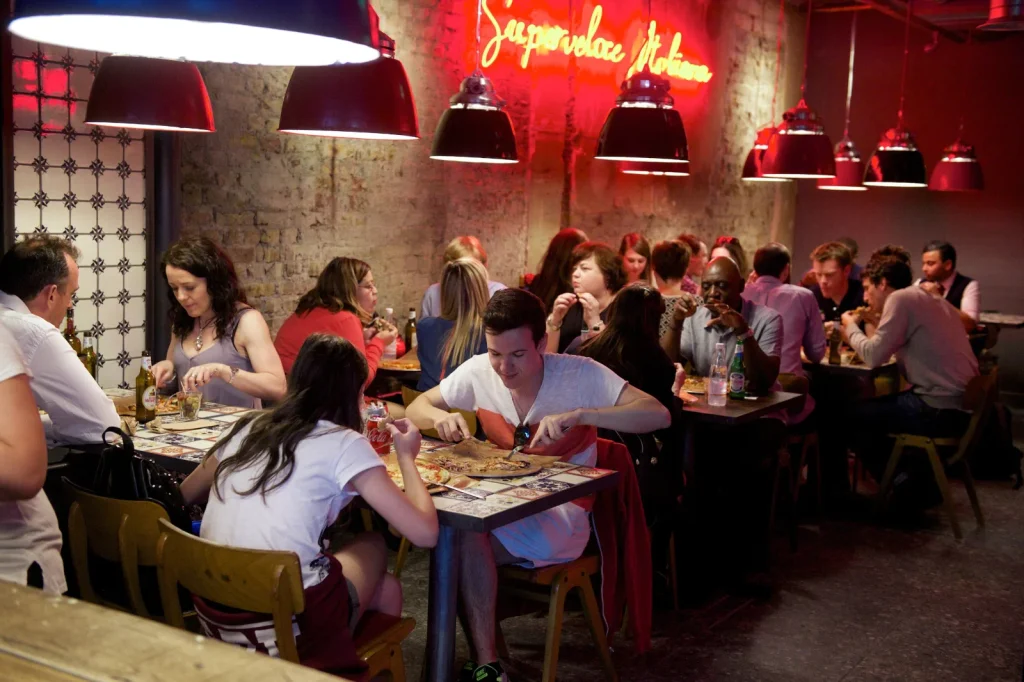 Groups eating pizza at Pizza Union Kings Cross