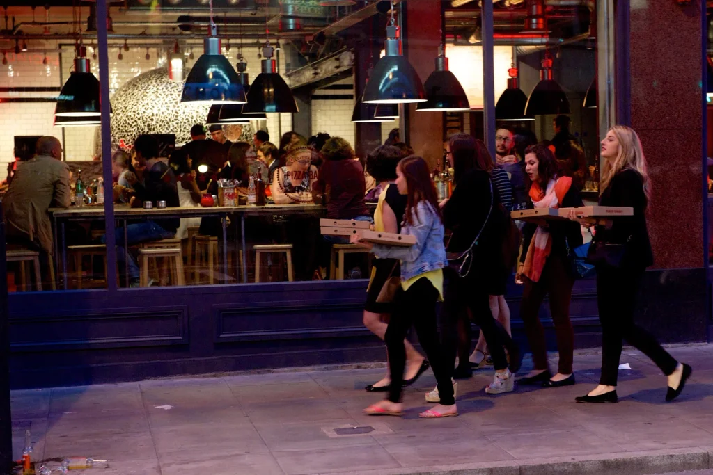Guests leaving Pizza Union with pizza boxes