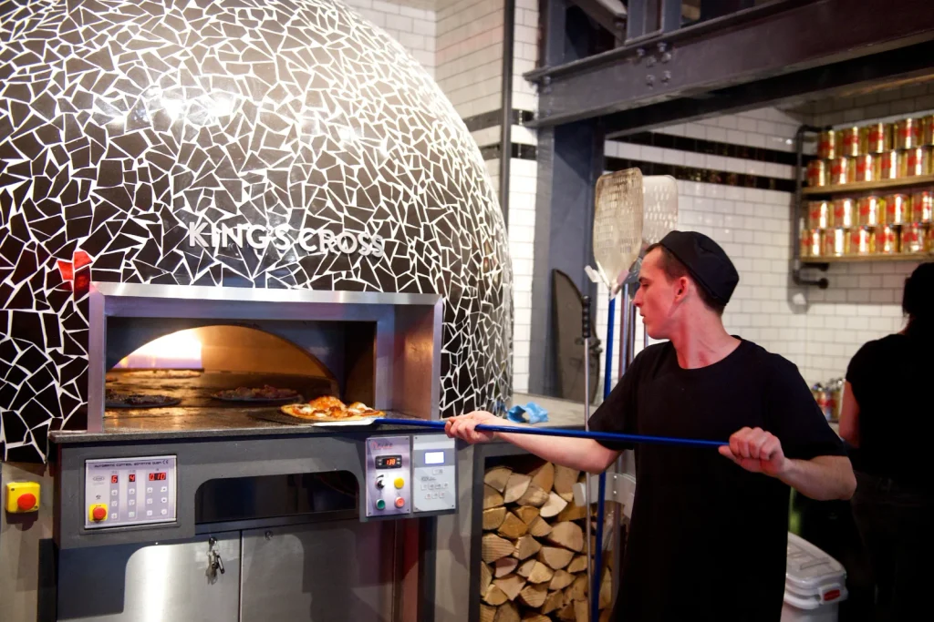 Pizza going into the oven at Pizza Union Kings Cross
