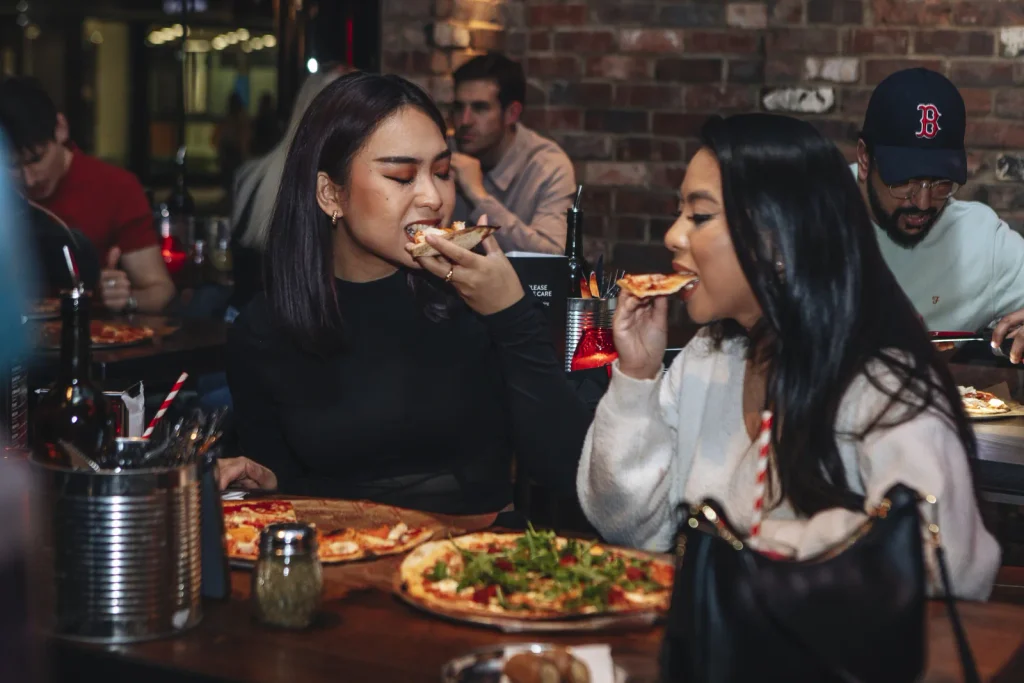 Friends eating pizza at Pizza Union Holborn near Covent Garden